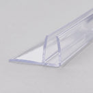 Clear PVC fin seal on pale grey, angled along its length - U-channel with a flat side fin
