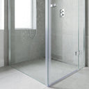 Vertical fin seal installed along the full closing edge of an 8-10mm frameless glass shower door, clear fin sealing the gap to the fixed panel
