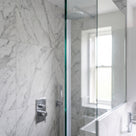 Clear fin seal fitted vertically on the upright edge of a thick 10-12mm glass shower screen