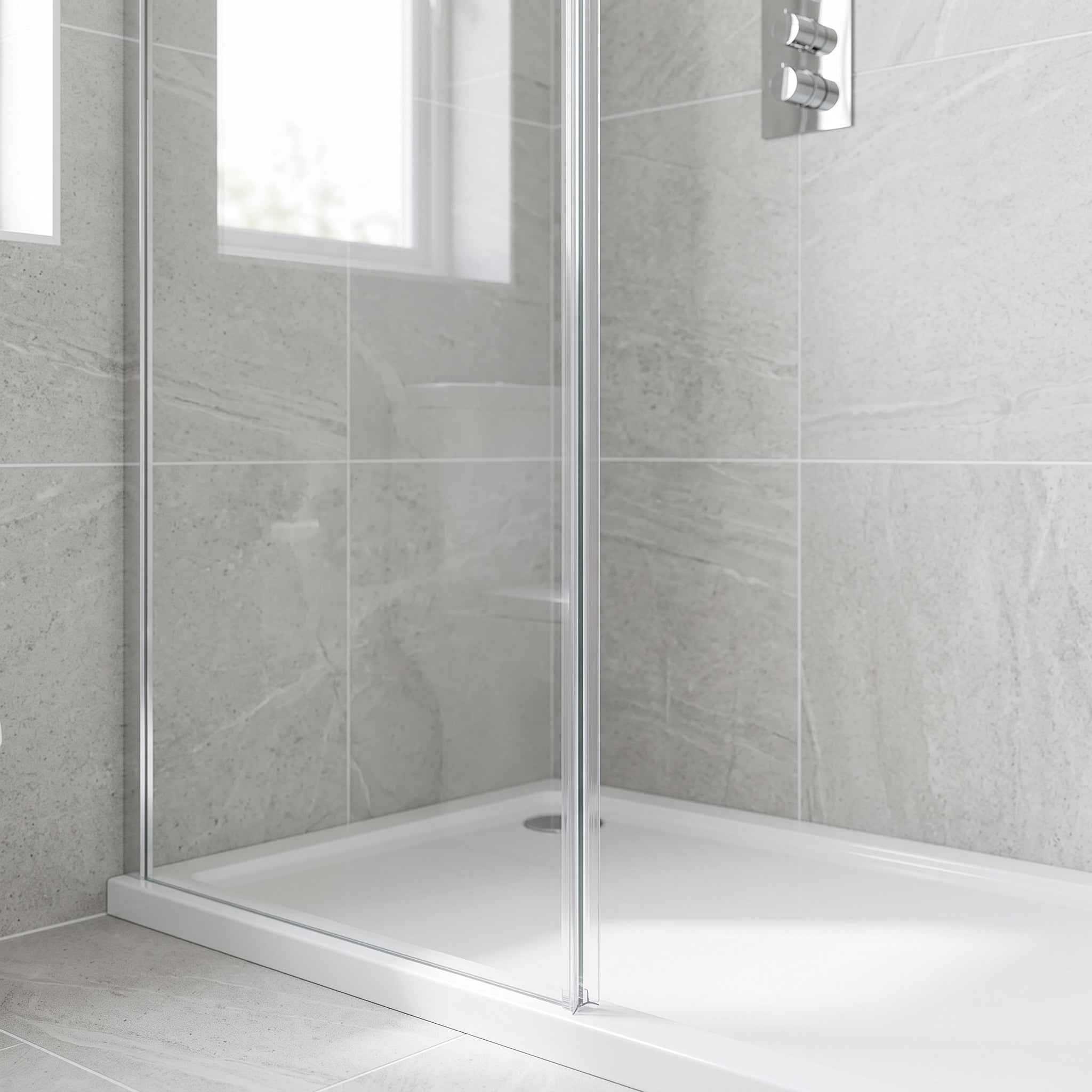 Clear rigid fin seal fitted vertically on the upright edge of an 8-10mm glass shower screen, sealing to the wall