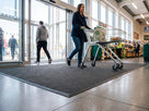 6.5mm surface-laid ribbed entrance matting inside a supermarket door with no matwell