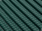 Macro view of the holly green diamond-cut tread — two rows of flat-topped pyramids along each rib with open drainage channels between the ribs