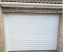 White gloss paint freshly applied to an up-and-over garage door on a UK house