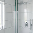 Clear U-section seal on the vertical edge of 8-10mm glass closing the corner gap to a second panel
