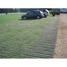 Two cars parked on a grassed overflow car park reinforced with green grass protection mesh beside gravel
