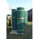 Three banded rolls of green grass protection mesh stacked upright on a wooden pallet ready for delivery