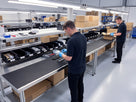 Open-rib anti-fatigue matting running along a light assembly and packing bench