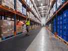 Anti-fatigue matting laid as a walkway runner down a warehouse pick-face aisle