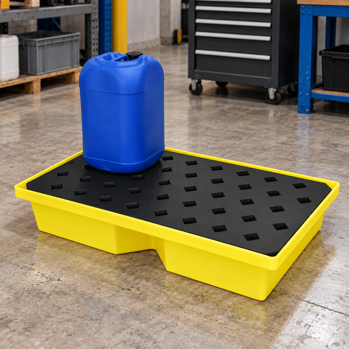 Yellow polyethylene spill tray with black removable grid in an industrial workshop; illustrative scene