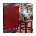Red gloss machinery enamel paint applied to a factory machine safety guard in a UK industrial unit