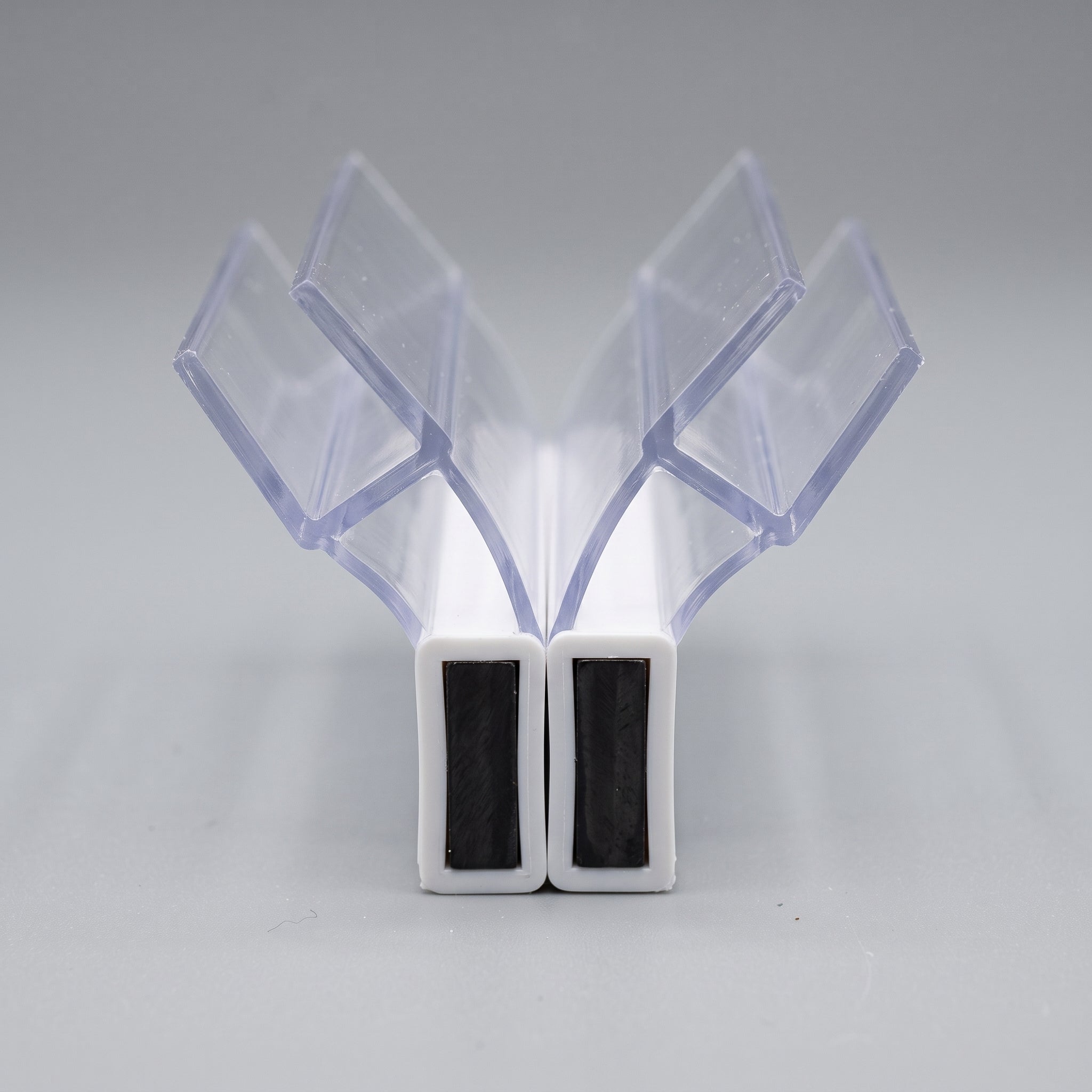 MAG002 magnetic seal pair profile - 8mm U-channels at 135 degrees with white-covered magnet housings meeting in the middle