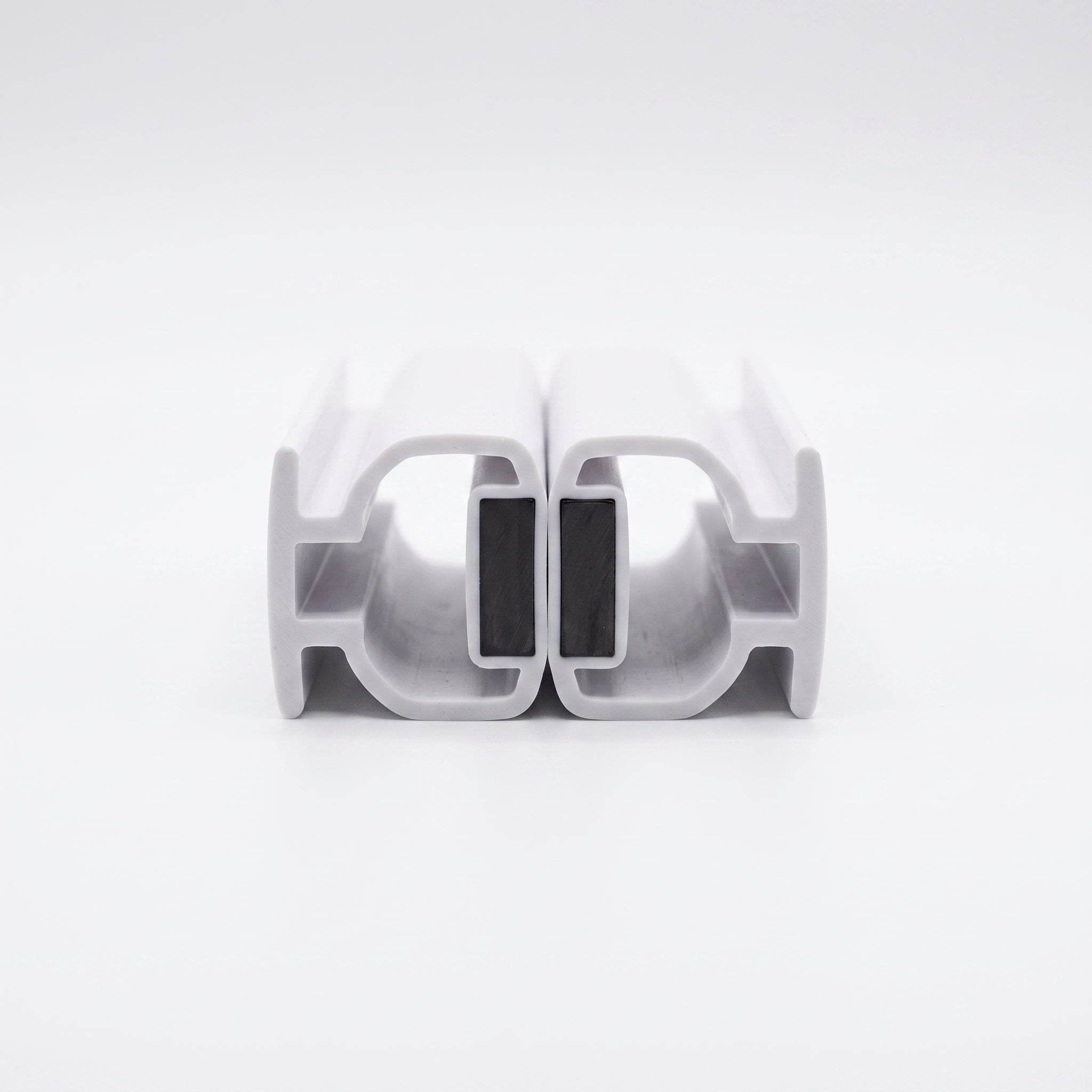Pair of MAG005 white magnetic seals snapped together magnet face to magnet face - 7mm T-bars, one magnet per piece