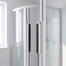 Pair of white magnetic channel seals fitted vertically on the meeting edges of a quadrant shower door