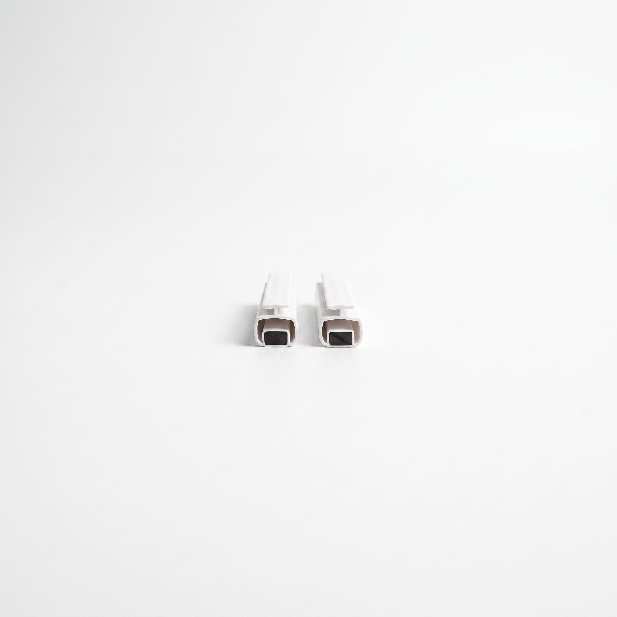 Pair of white MAG008 magnetic channel seals - 4.5mm T-head with magnet strip inside 10mm body