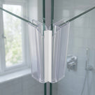 Two clear seals with a white magnet strip meeting where glass shower panels close at a corner
