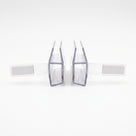 Two clear magnetic seal profiles facing each other on white, wide white magnet blocks on flexible arms