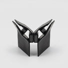 Two black seal profiles opened into a V on white, feathered lips above and magnets meeting at the base