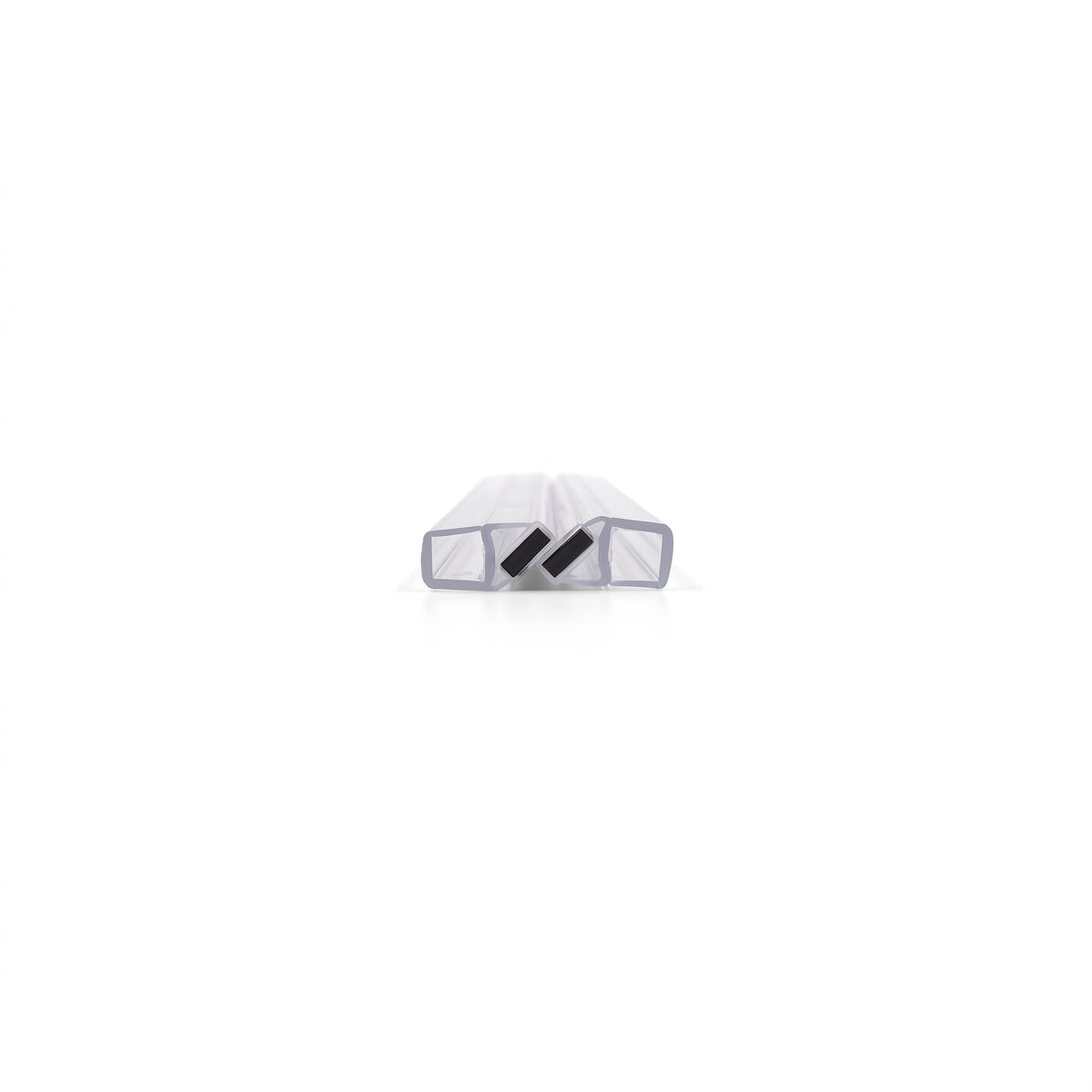 Two pale magnetic seal profiles closed together on white, small black magnets tilted face to face