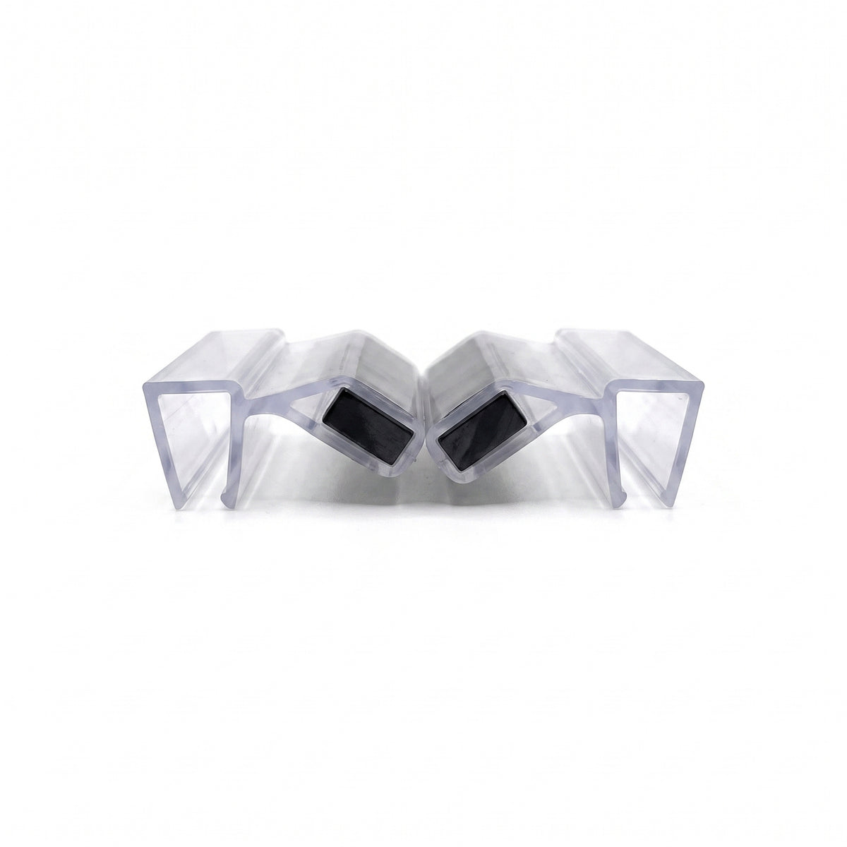 Two clear magnetic seal profiles meeting at an angle on white, black magnets tilted face to face