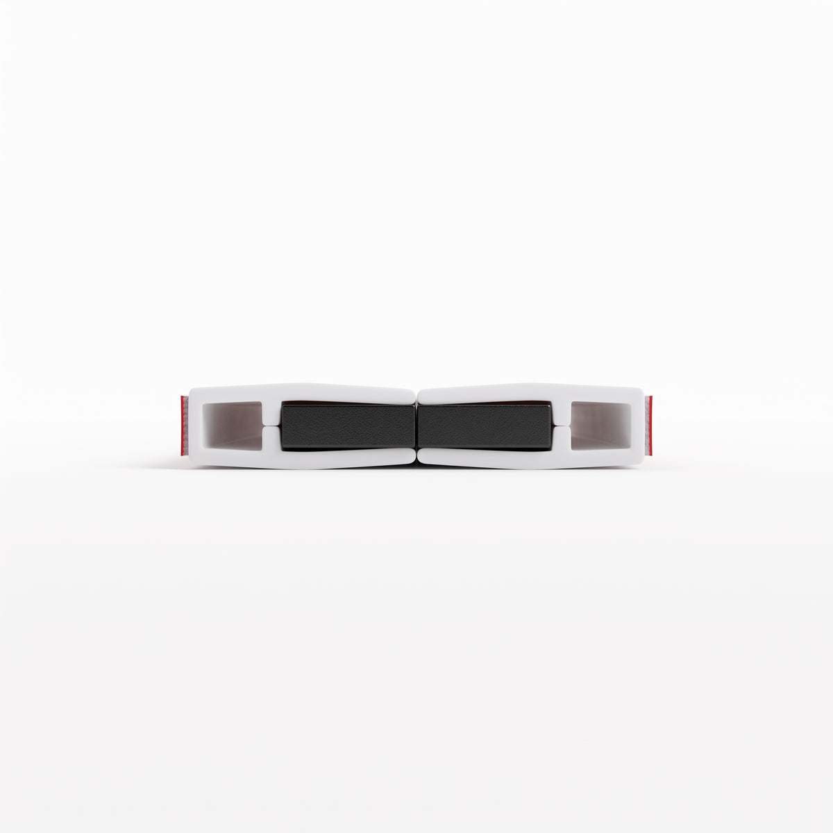 Two white self-adhesive seal bodies end-on, joined at black magnets with red tape liners at the outer ends