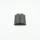 Two black magnetic seal strips butted together on white, ribbed faces upward, cut ends towards the camera