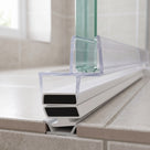 Magnetic seal set fitted on a shower tray, clear over-glass channel above a white housing with black magnets