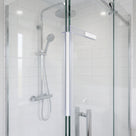 White magnet strip running full height where a sliding shower door meets the fixed glass panel