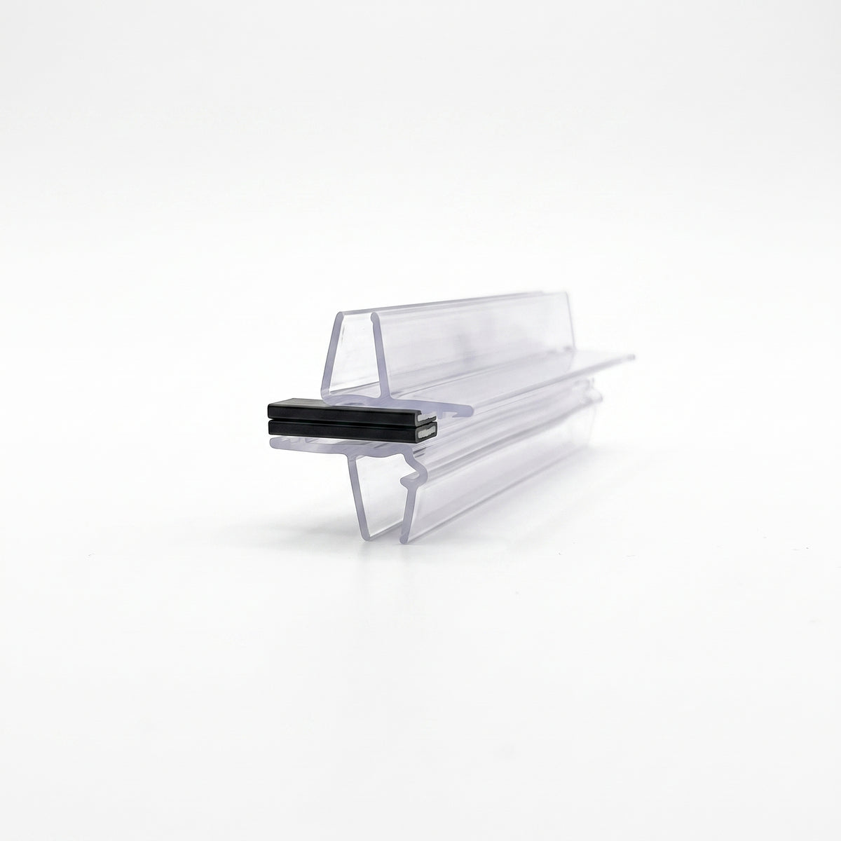 Clear offset magnetic seal profiles engaged on white, a black magnet block clamped between the two arms