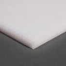 Small milky white HDPE sheet angled on a grey backdrop, two clean-cut edges meeting at the near corner