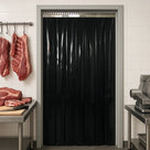 Black PVC strip curtain in a tiled butchery doorway, hanging meat cuts and a slicer either side