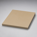 Tan-coloured PEEK sheet, angled studio shot on a grey background