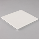 Square off-white PET slab angled on a plain grey ground, satin face and a clean square-cut edge