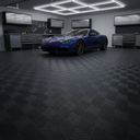 Black open-grid interlocking floor tiles in a dark garage, blue sports car under bright ceiling lights
