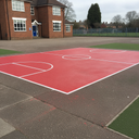 Red playground paint games court markings on a UK school playground
