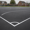 White playground paint boundary and game lines on a UK MUGA court