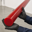 Red polyurethane rod held by gloved hands, glossy cut end visible