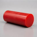 Red polyurethane rod, glossy cylinder on a plain grey background