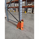 Orange steel U-shape racking guard with black and yellow hazard stripes, bolted at a racking upright base