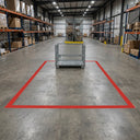Red floor marking tape outlining a quarantine area with a mesh stillage cage inside the marked rectangle