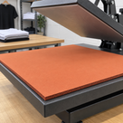 Illustrative textile heat press application with red-oxide silicone sponge sheet, 915mm × 1m × 4.8mm