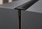 Illustrative use case of black 19mm rigid PVC barbed T section installed between panels