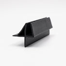Black seal offcut on white, glass channel with an angled top fin and a straight lower blade