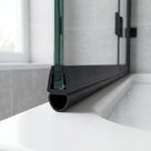 Black seal with a large hollow oval bulb on a glass screen edge, resting on a white tray