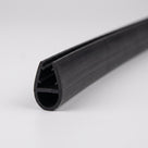 Length of black shower seal on white, glass channel above a large round hollow bubble