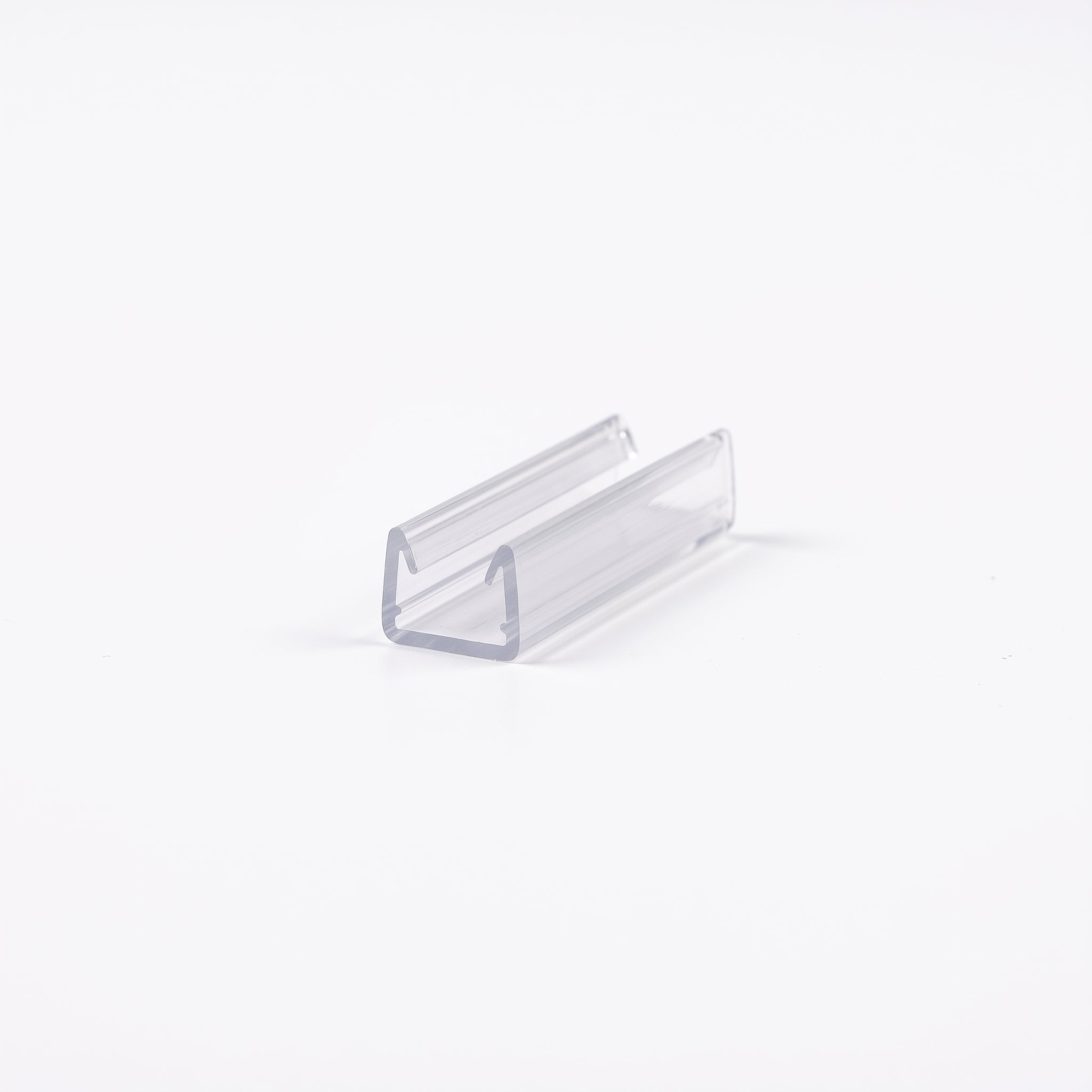 Cut length of SEAL026 clear U channel seal - 13mm tall, 10mm mouth widening to 12mm inside, for 10-12mm glass