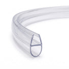 Clear seal coiled into a ring on white, cut end forward showing the glass channel above a hollow teardrop bubble