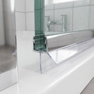Chrome-topped clear seal on a glass door bottom edge above a white tray, chrome tap behind