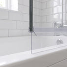 Clear seal with a long straight fin under a bath screen with a black frame post, white bath below