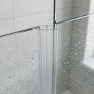 Close view of a clear ribbed joint seal on the edge of two glass panels, water-speckled glass behind