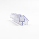 Cut length of clear shower seal on white, angled view - glass channel with a triangular blade and flat wiper